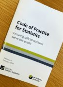 A copy of the code of practice for statistics on a table top.