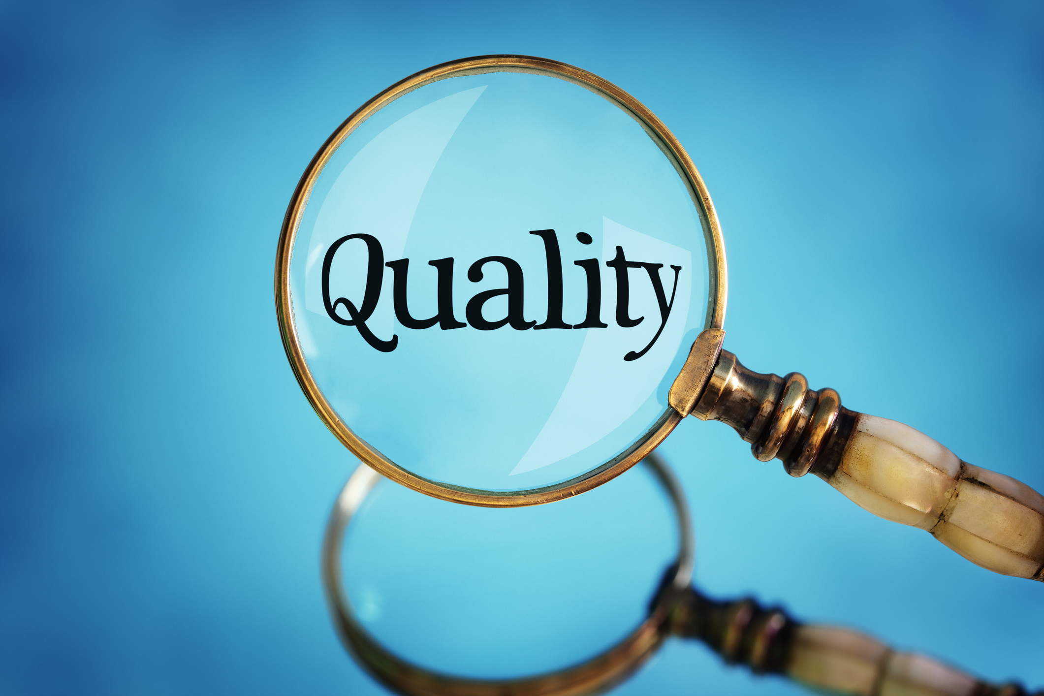 Magnifying glass focus on word quality concept for quality control, customer satisfaction and excellence