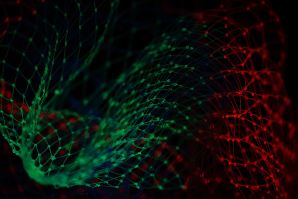 An abstract image of two green and red interconnected graphs