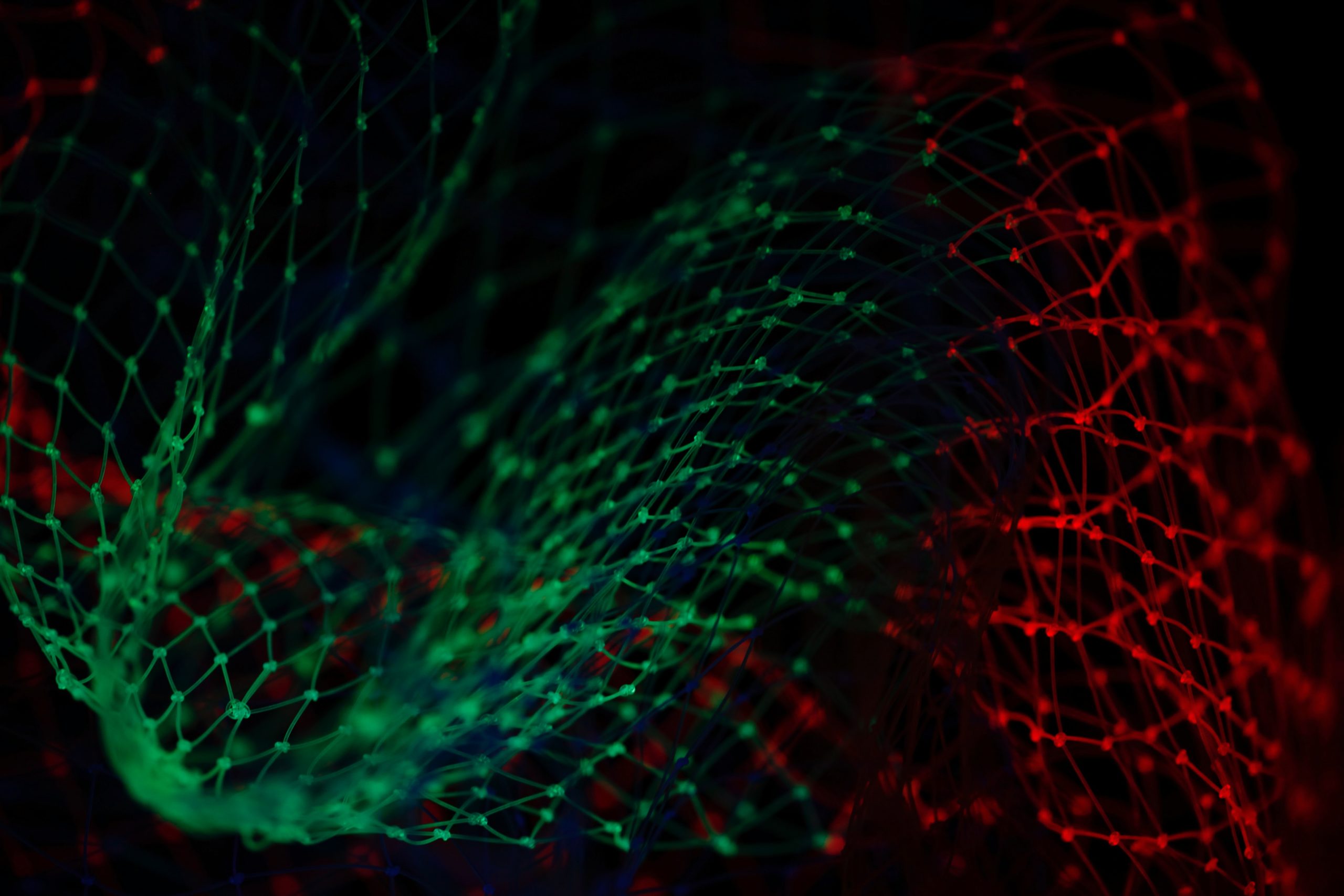 An abstract image of two green and red interconnected graphs