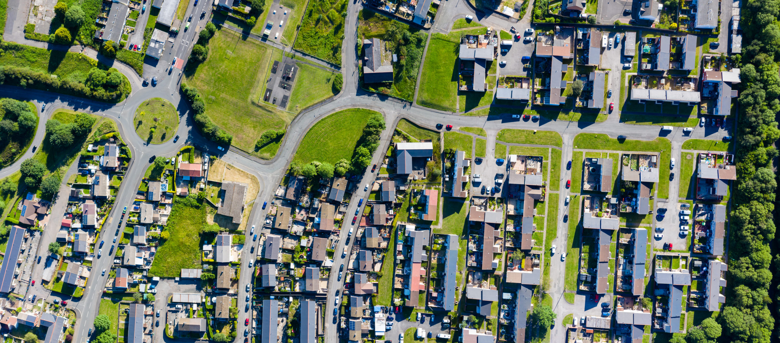 Aerial drone view of small winding streets and roads in a residential area of a small town