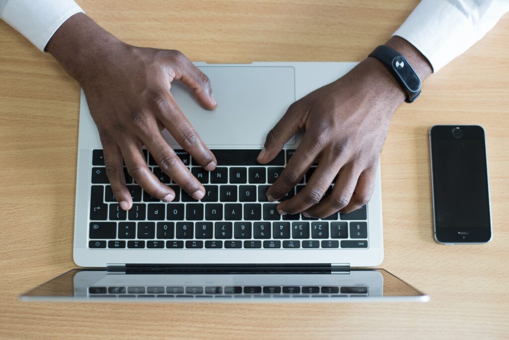 Image of mans hands typing on keyboard