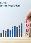 A hand placing three blocks on a table with the letters "GDP" next to a bar chart