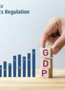 A hand placing three blocks on a table with the letters "GDP" next to a bar chart