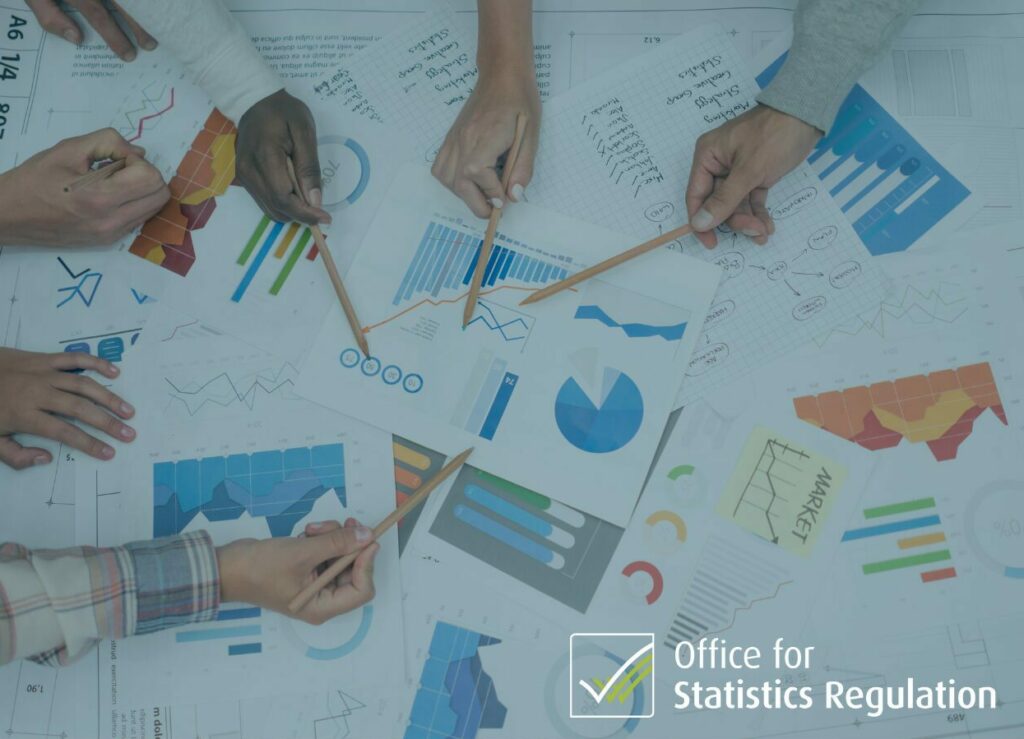 Printed statistics on table with various hands holding pencils