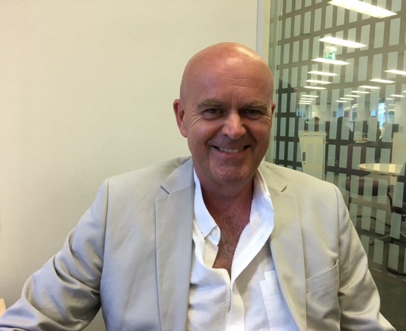 Richard Laux with a cream background