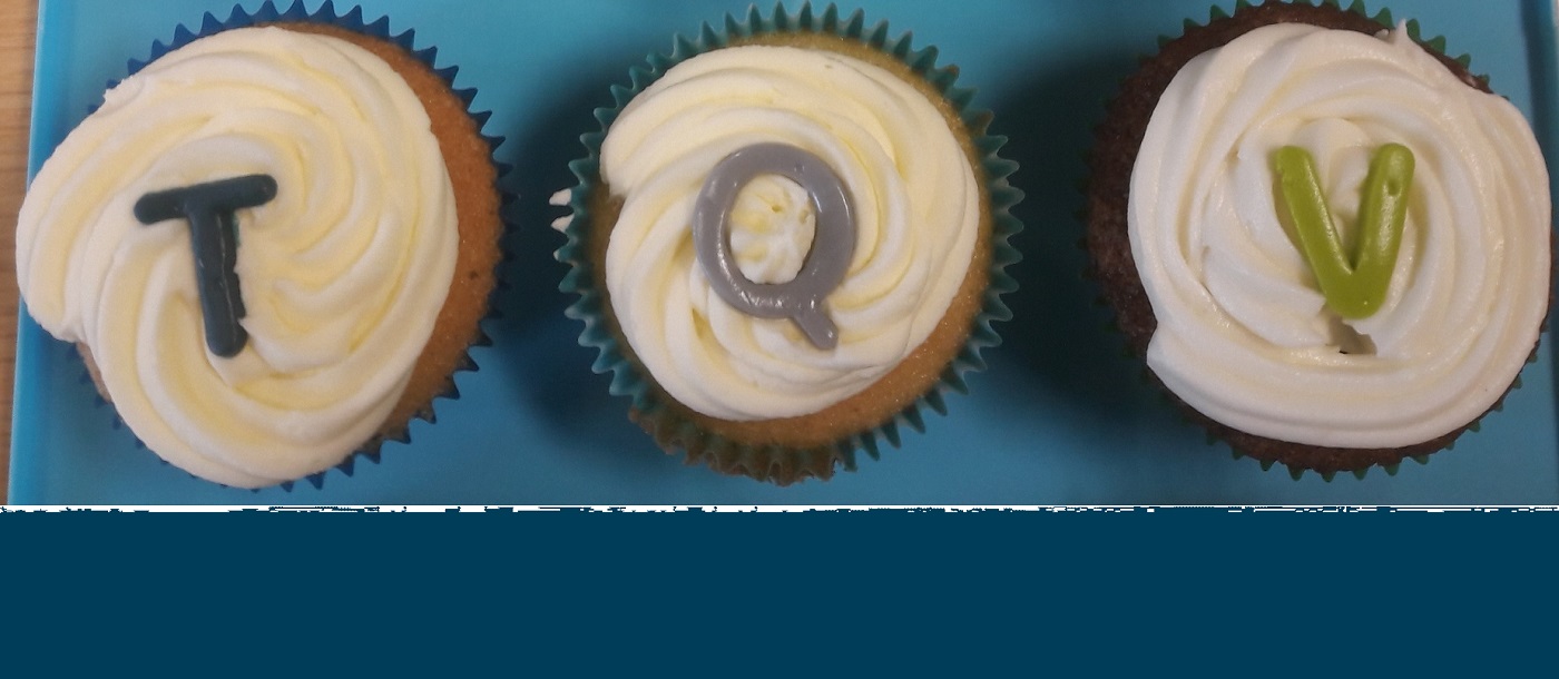Cakes spelling out TQV