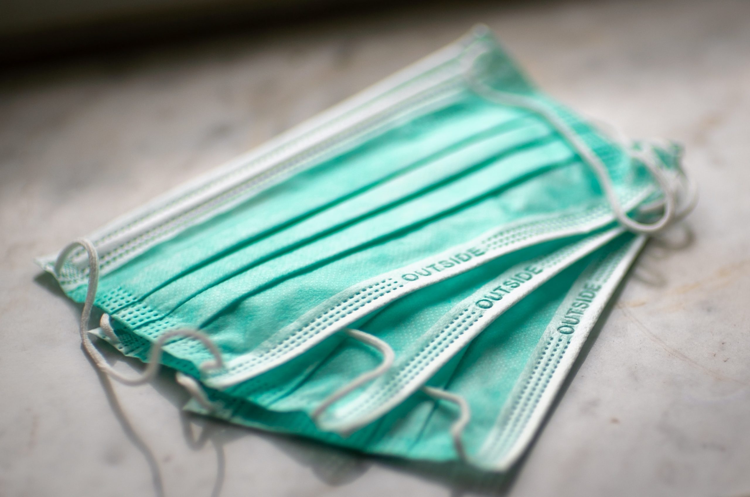 A photo of 3 medical face masks on a desk