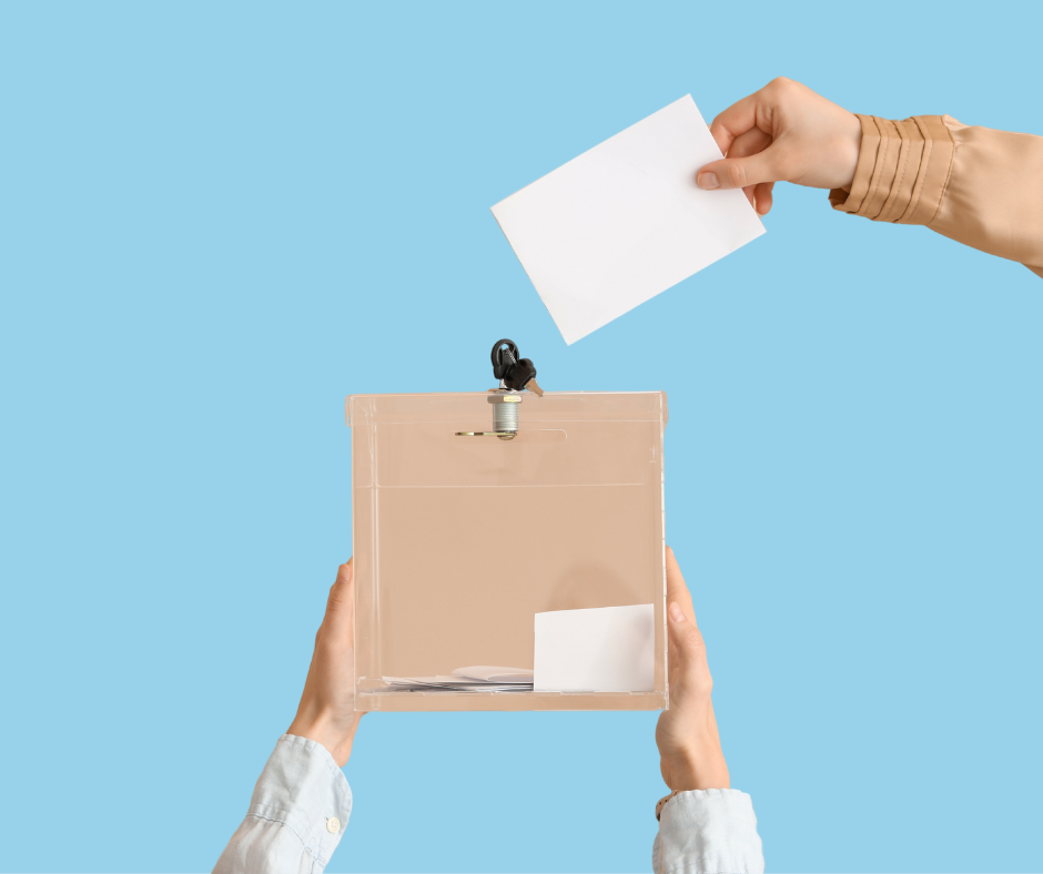 two hands holding a polling box and another hand reaching over to place a voting card into it