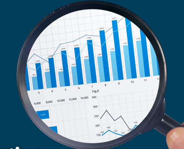 celebrating world statistics day - a magnifying glass with graphs