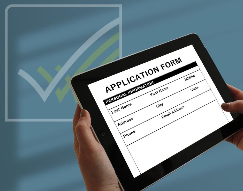 hands holding a tablet device with an application form on the screen