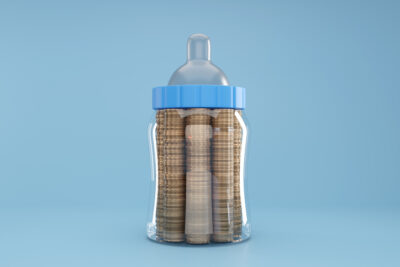 Decorative image. A baby bottle with coins