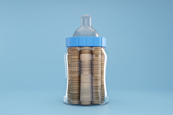 Decorative image. A baby bottle with coins