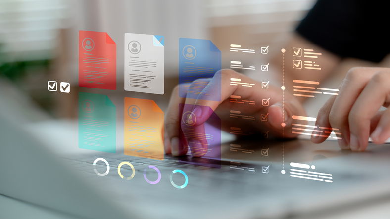 A decorative image of a person working on a laptop with document icons