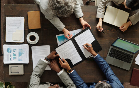 Decorative image of colleagues working at an office desk