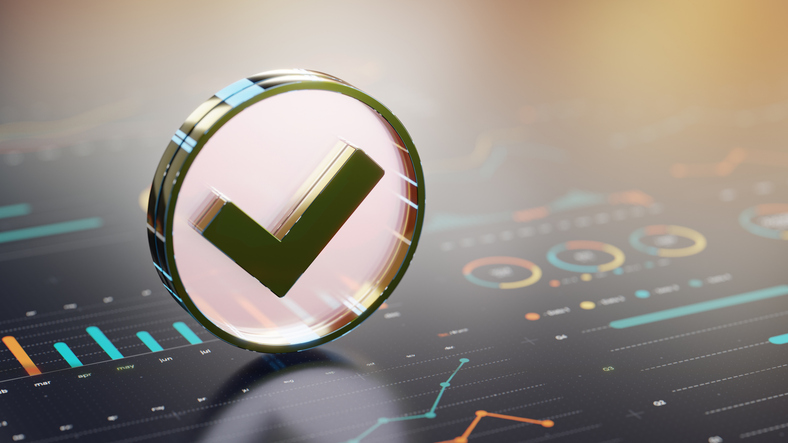 A tick check mark balancing on top of some statistics